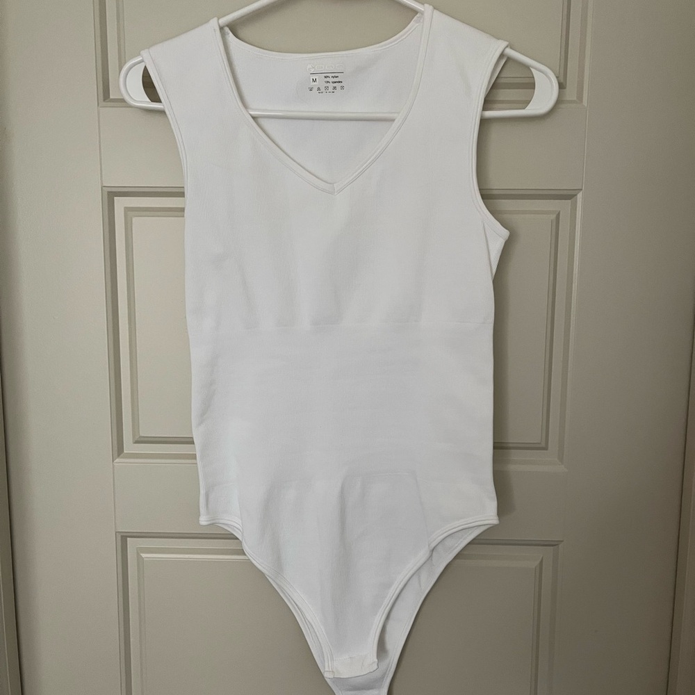 White V- neck Bodysuit. NEVER WORN.